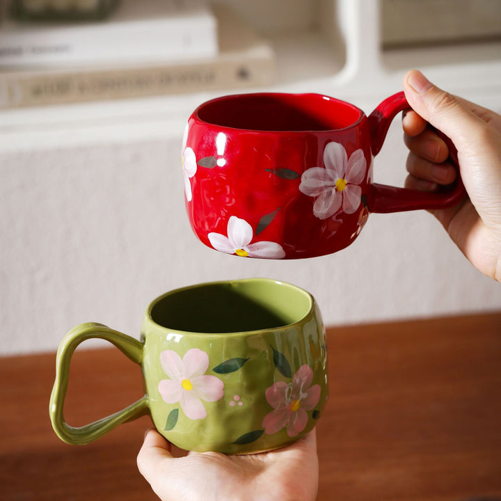 Ceramic mug with hand-painted stripes and flower design