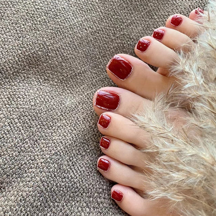 Artistic toenail art with rhinestone and glitter elements Kalsten