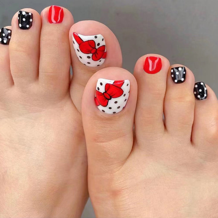Artful toenail design with elegant bow motifs Kalsten