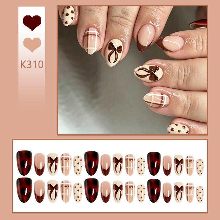Artificial nail set with elegant bow and caramel designs Kalsten