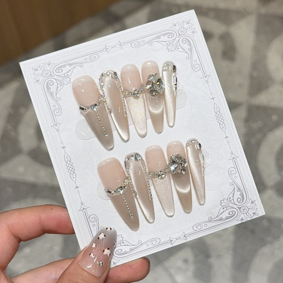 Glamorous nail tips with rhinestone and glitter effects Kalsten