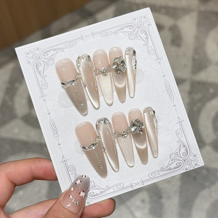 Glamorous nail tips with rhinestone and glitter effects Kalsten