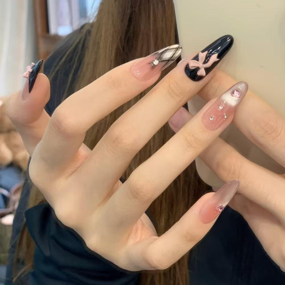 Artificial nails with playful bow and glitter accents Kalsten