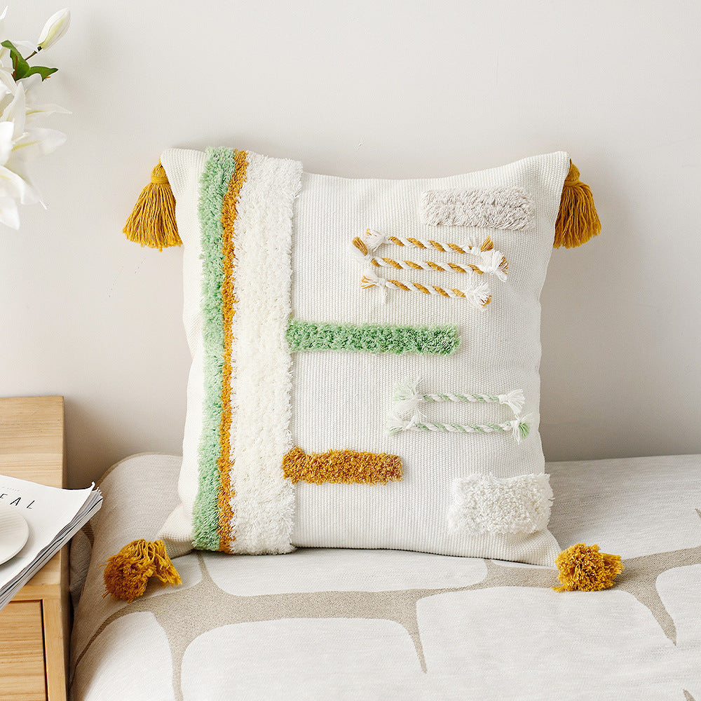 woven decorative cushion cover with tufted relief stripes and corner tassels