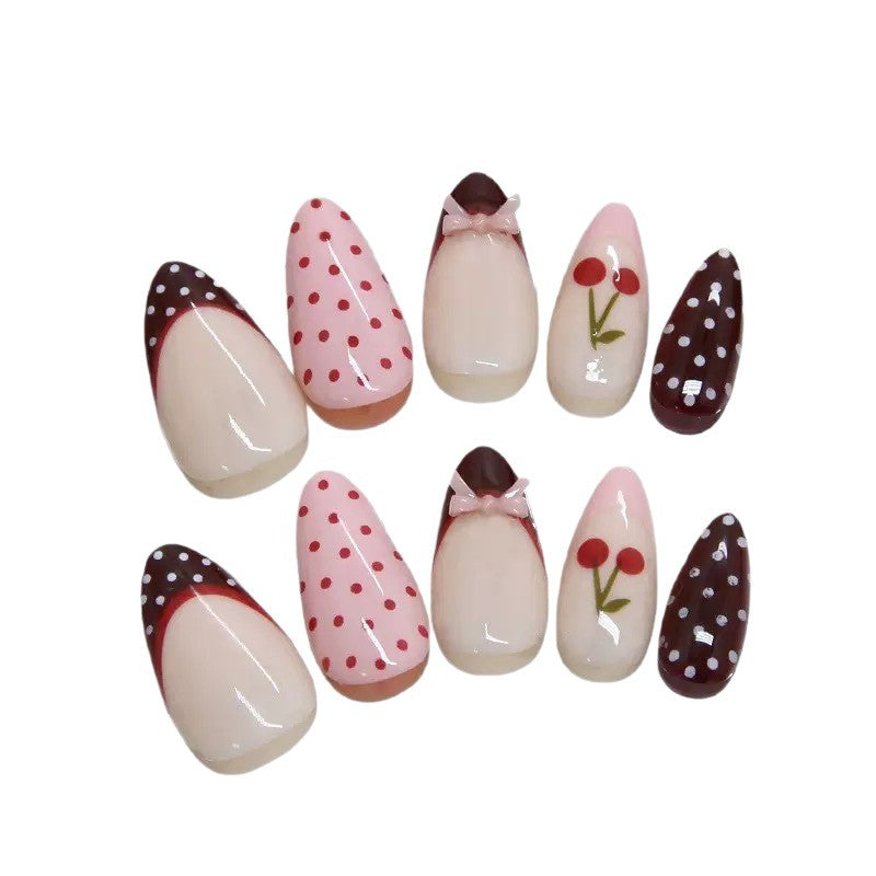 Artfully designed nail tips with cherry and dot motifs Kalsten