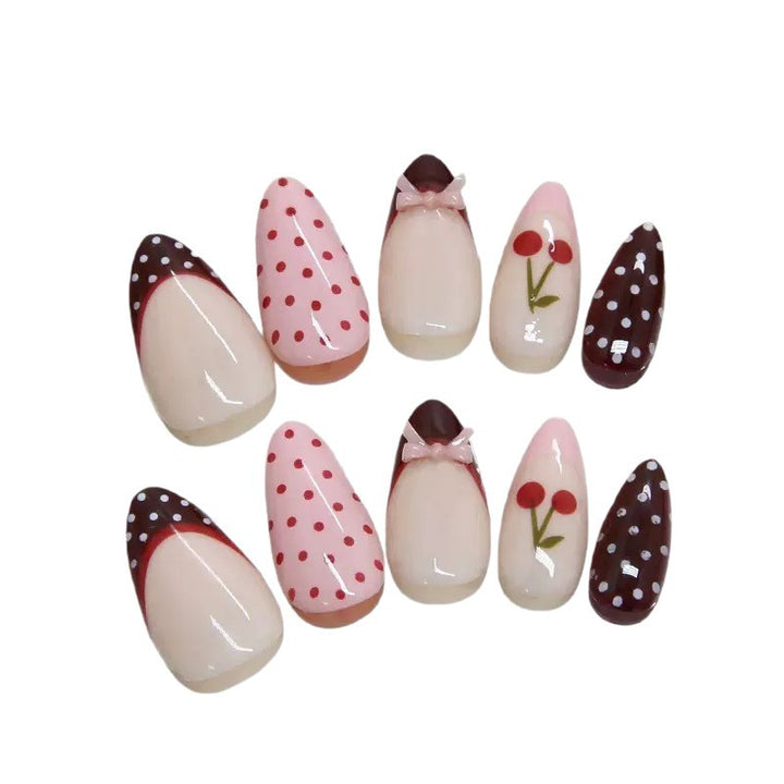 Artfully designed nail tips with cherry and dot motifs Kalsten