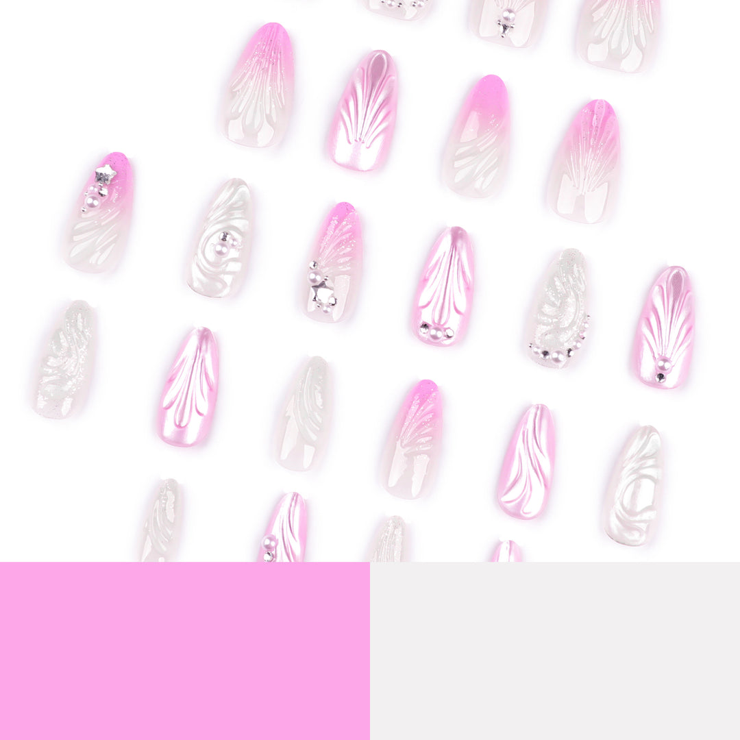 Artificial nail art with elegant swirl design and pearl embellishments Kalsten