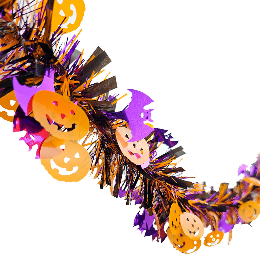 Shiny Halloween garland made of plastic with pumpkin confetti and dense fringes