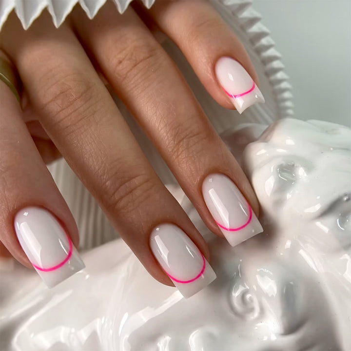 Stylish artificial nails with elegant French tip and modern accents Kalsten