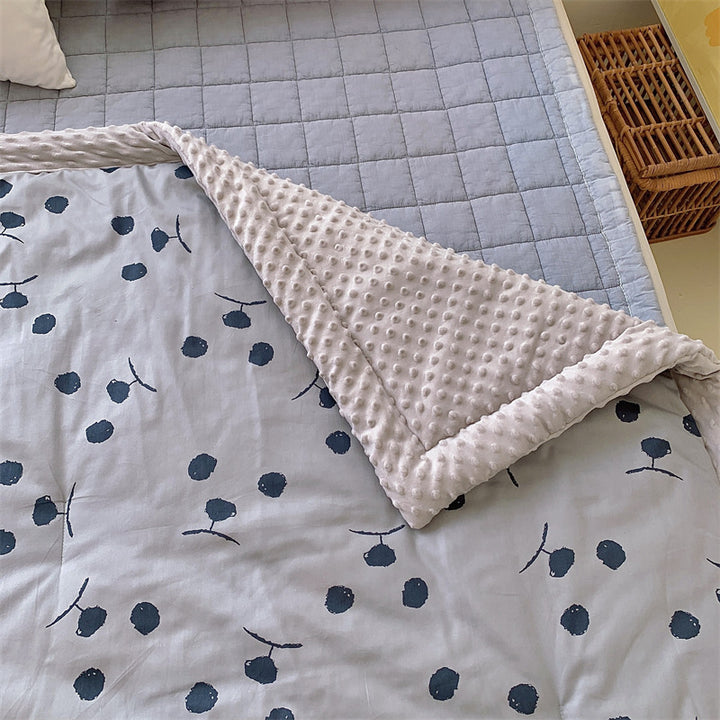 Children's quilt with colorful dinosaur print and soft minky border