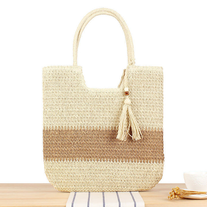 Fashionable beach tote bag made of woven natural material with fringed detail Kalsten