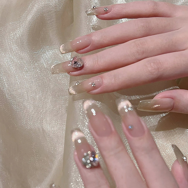 Acrylic nail set with glamorous glitter accents and elegant jewelry embellishments Kalsten
