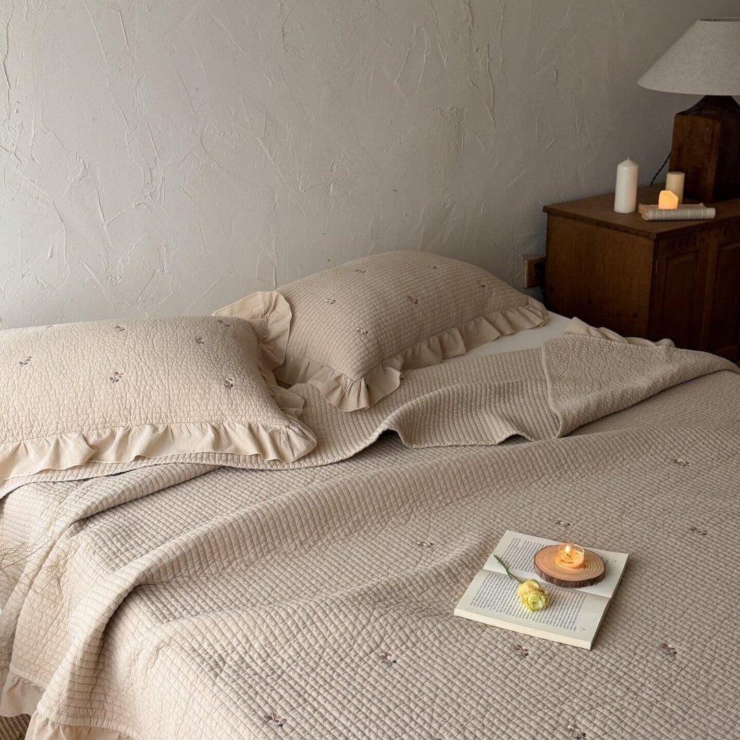 Quilted bedspread and cushion set with frill and delicate flower embroidery
