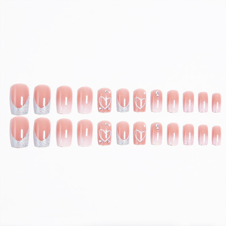 Artificial nails with sparkling heart designs and glitter details Kalsten