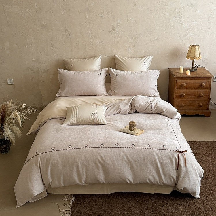 Embroidered bed linen set made of cotton-linen with delicate floral embroidery, wavy edge and ties.
