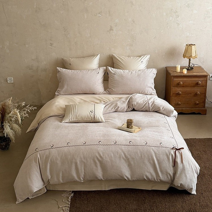 Embroidered bed linen set made of cotton-linen with delicate floral embroidery, wavy edge and ties.