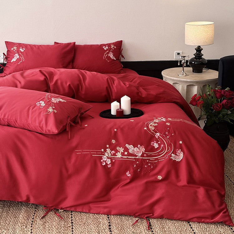 Satin bedding set with floral embroidery, ribbon ties and silky surface