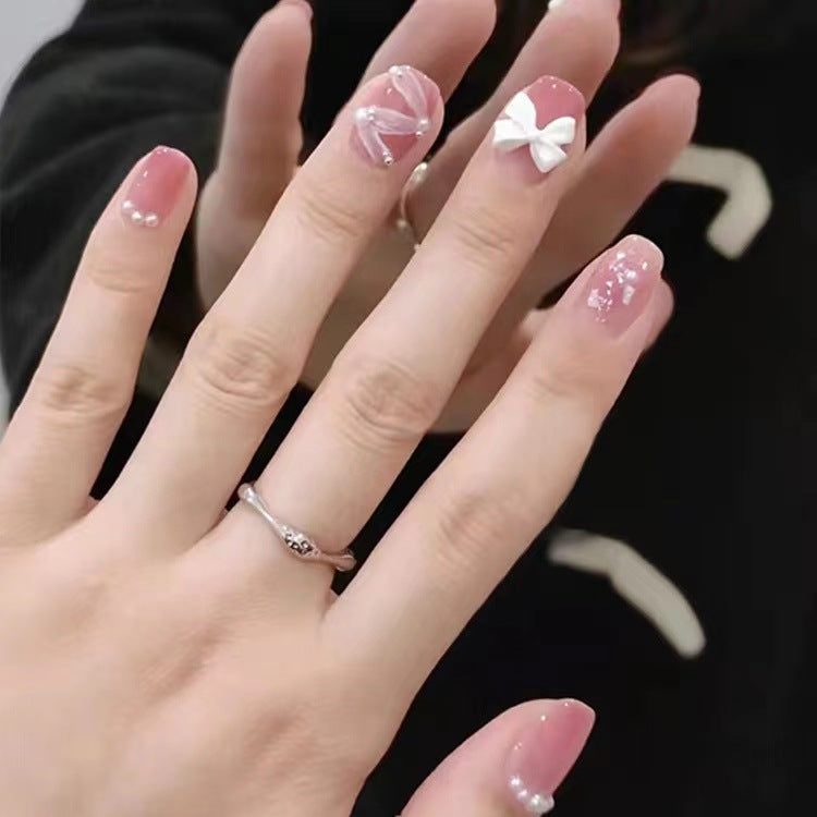 Glamorous nail art with pearl and bow accents Kalsten