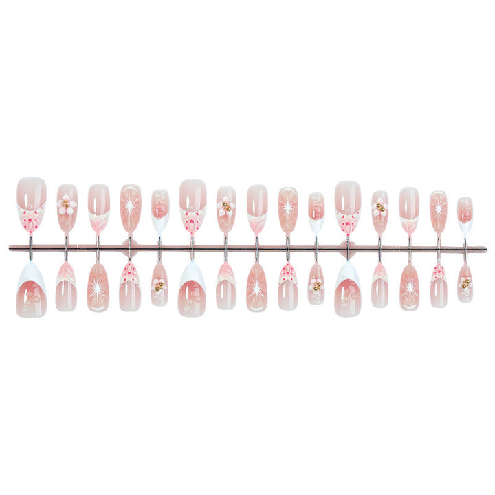 Creative acrylic nail set with floral accents and glitter decorations Kalsten