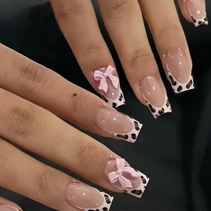 Acrylic nail set with playful bows and modern accents Kalsten
