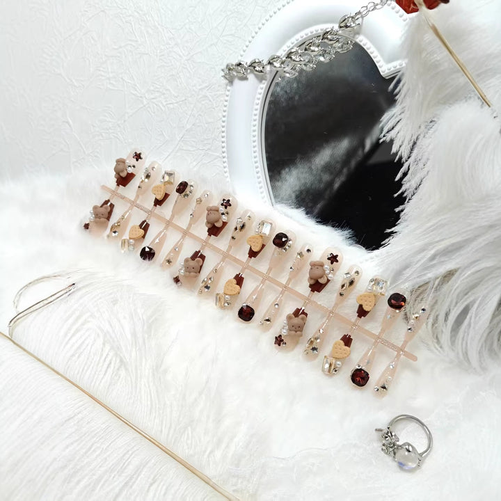 Creative acrylic nails with animal motifs and glitter accents Kalsten
