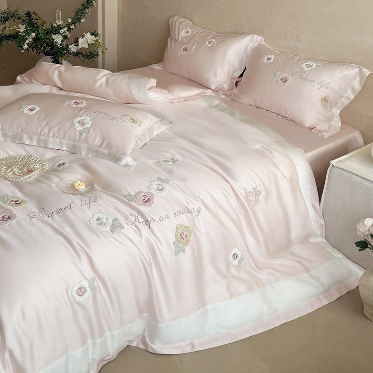 Luxurious satin bedding set with embroidered rose appliqués and silky glossy finish