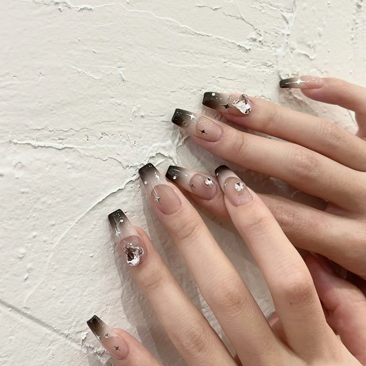 Artificial nail extensions with elegant ombre design and glitter accents Kalsten