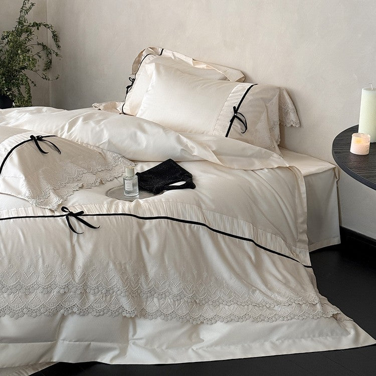 Fine cotton satin bedding set with lace ruffle, contrasting decorative ribbons and hotel closure