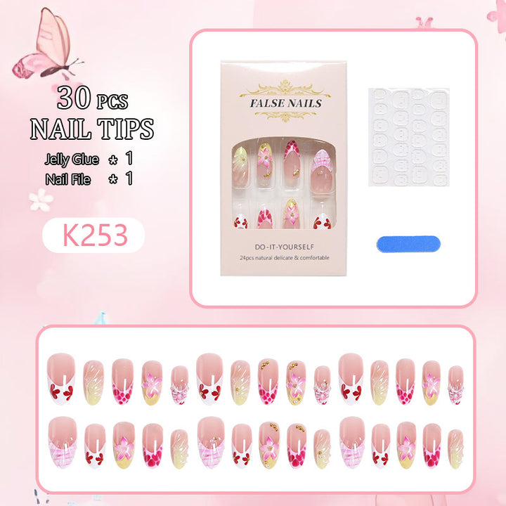 Artificial nails with floral accents and glitter decorations Kalsten