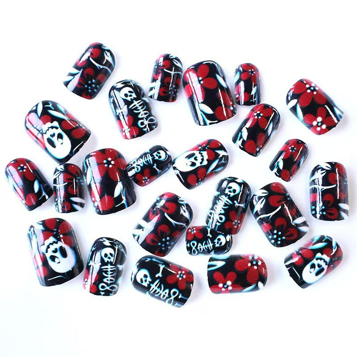 Creative nail art with skull motif and floral elements Kalsten