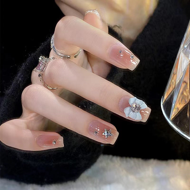 Artistic nail tips with floral and glittering accents Kalsten