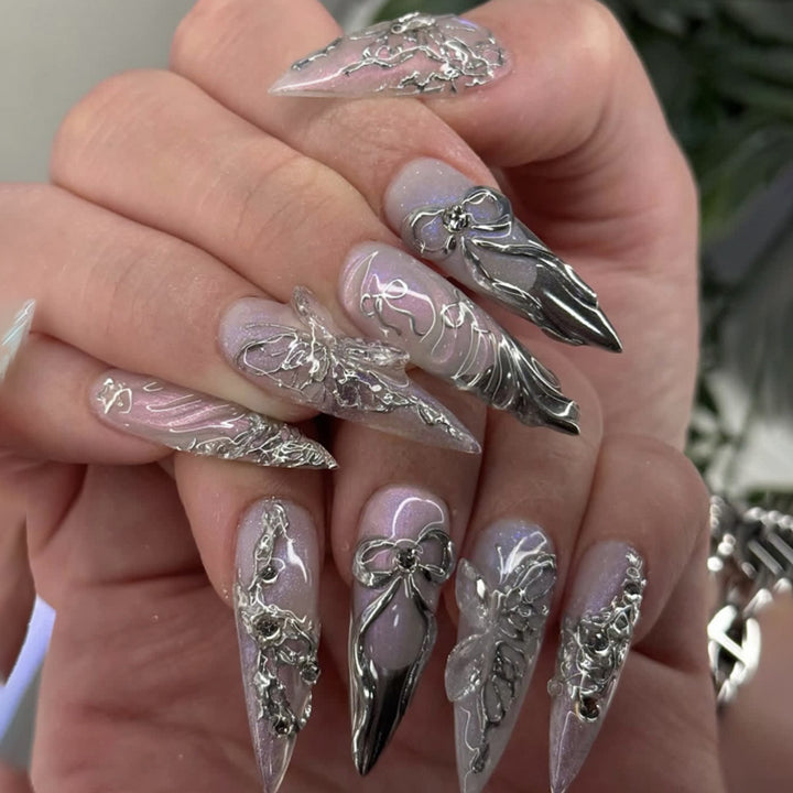 Artful stiletto nails with delicate silver casting decoration Kalsten