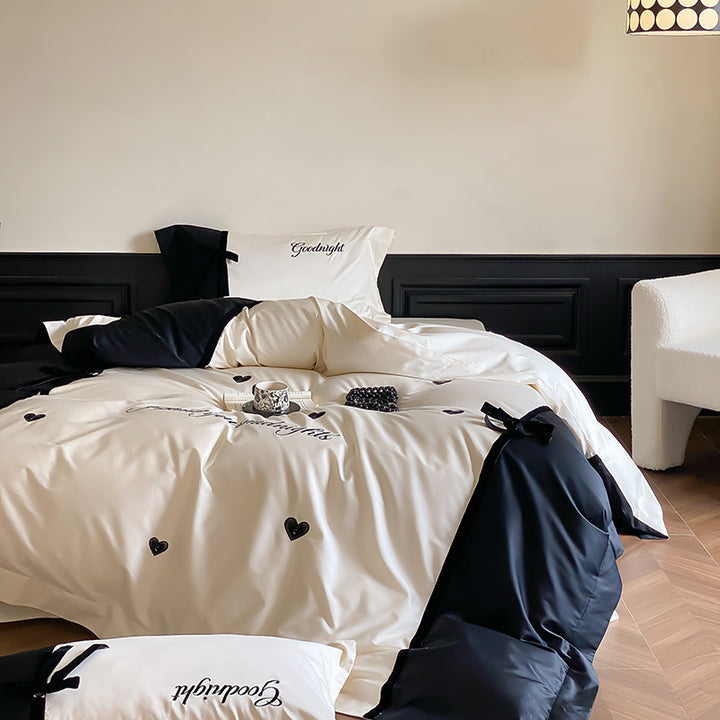 Reversible satin bedding set with bow appliqué and embroidered lettering