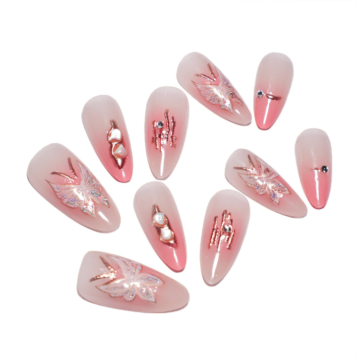 Artificial nail extensions with floral motifs and glitter accents Kalsten