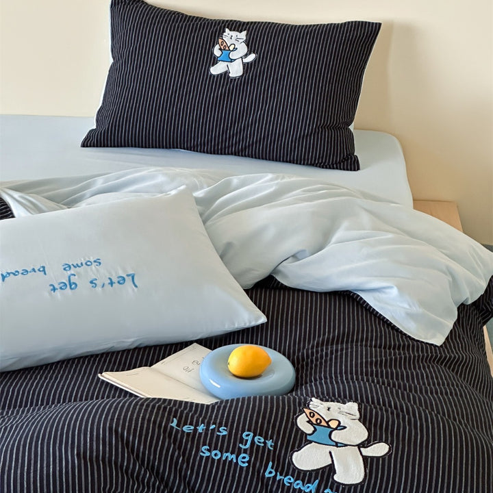 fine striped bed linen set with embroidered cat motif and soft cotton satin