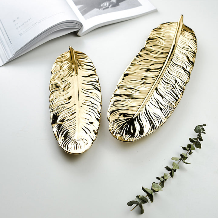 Leaf-shaped decorative tray made of metal with a textured surface