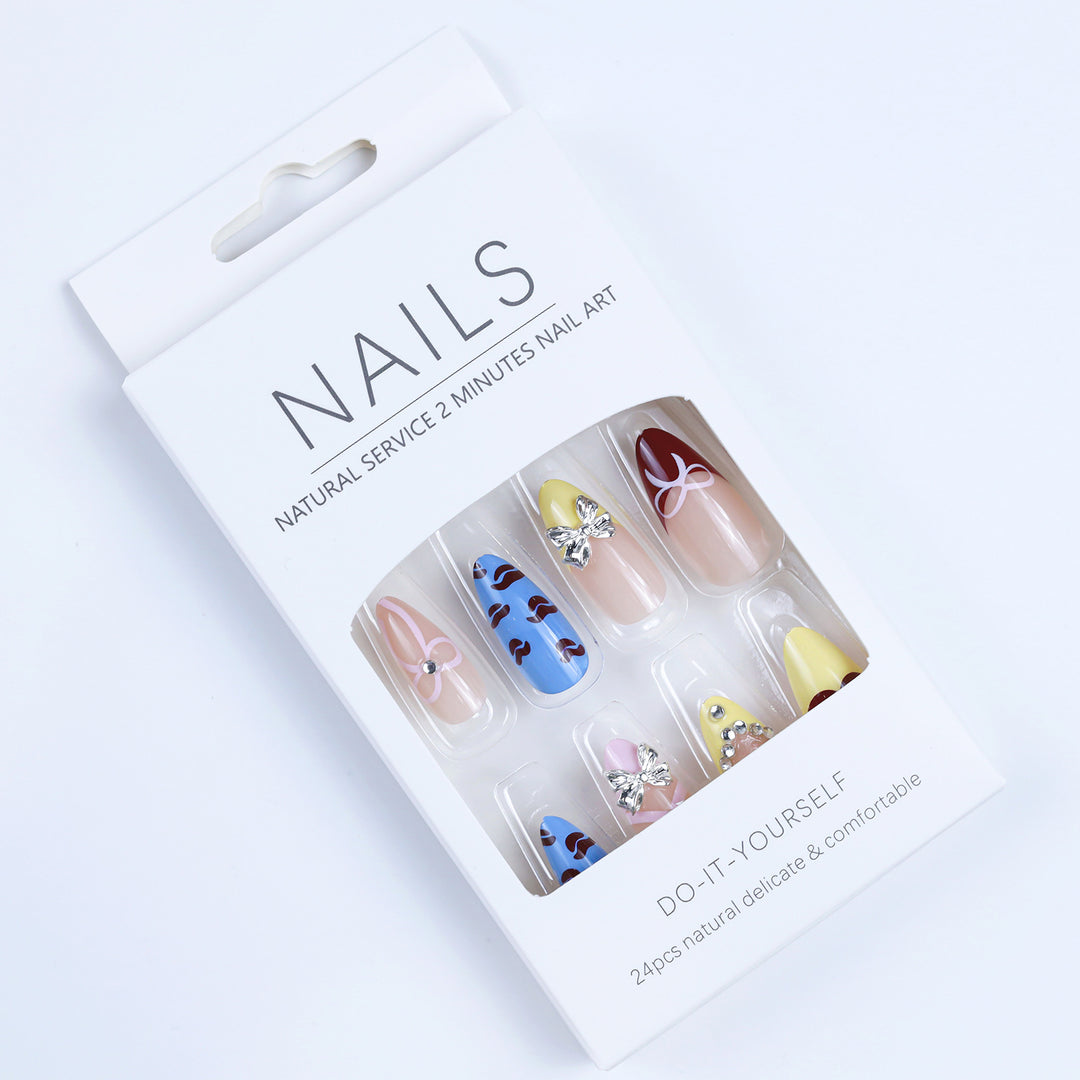 Artificial nails with playful design and 3D embellishments Kalsten
