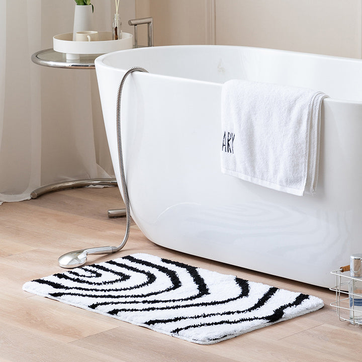 Fluffy bath mat in a graphic wave relief with anti-slip base Kalsten