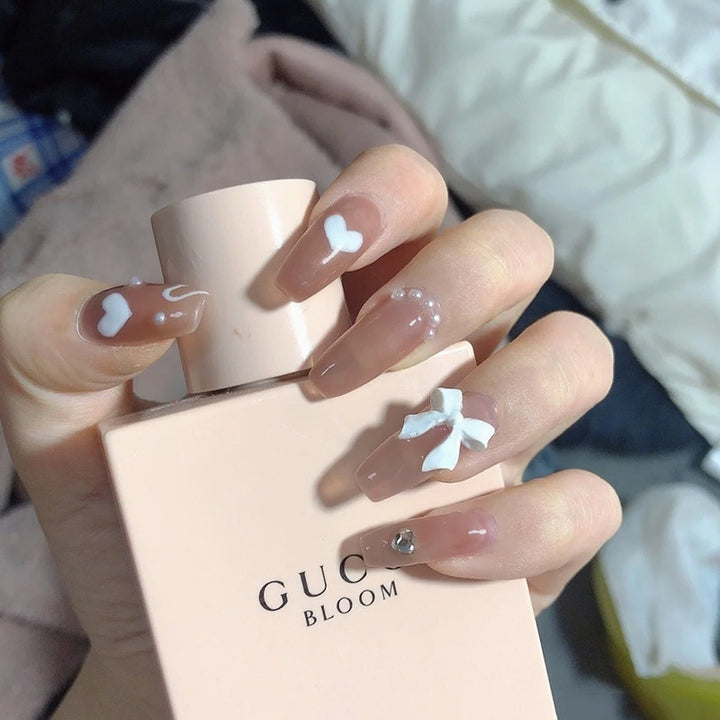 Glamorous artificial nails with heart design and glittering accents Kalsten