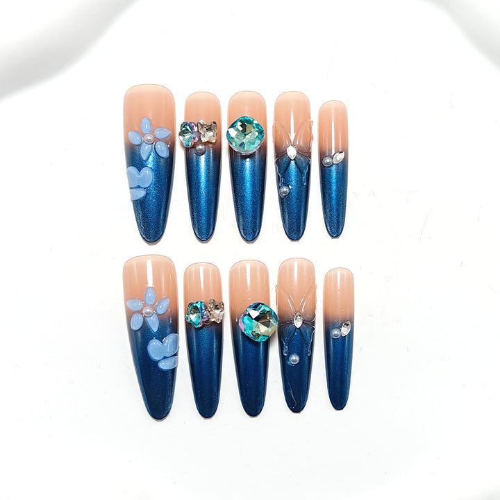 Artificial nails in elegant design with artistic decorations and glitter accents Kalsten