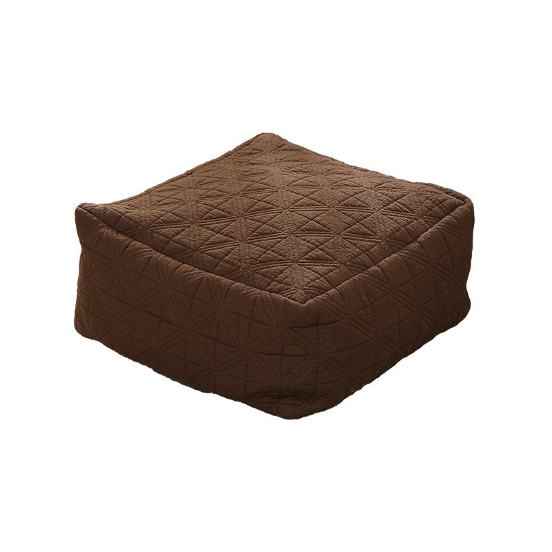 Padded footstool pouf with quilted cover fabric and shape-stable core