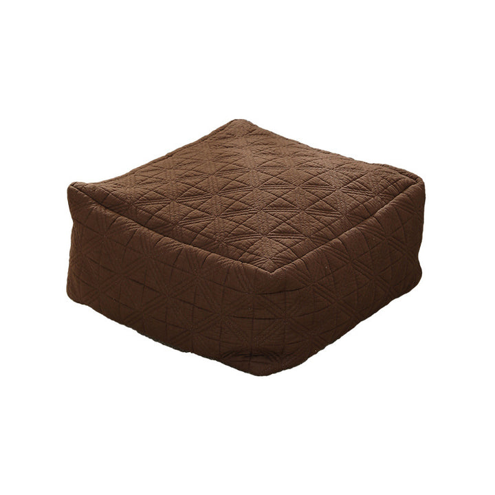 Padded footstool pouf with quilted cover fabric and shape-stable core