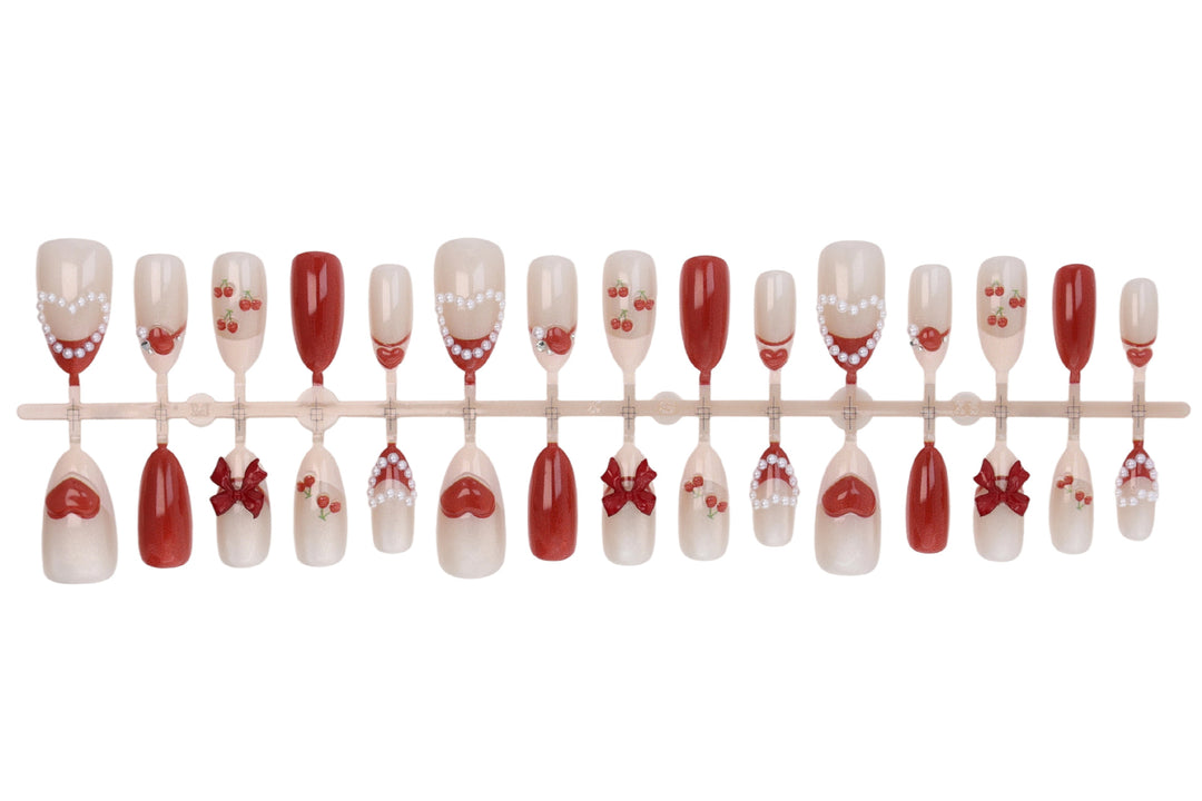 Artificial nail set with romantic berry designs and glamorous embellishments Kalsten