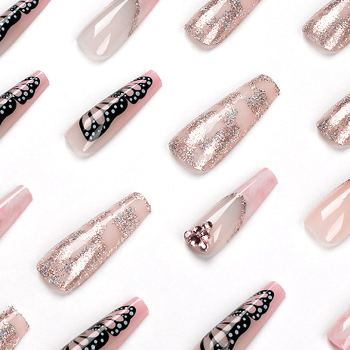 Glamorous nail extensions with beautiful butterfly motifs and glitter accents Kalsten