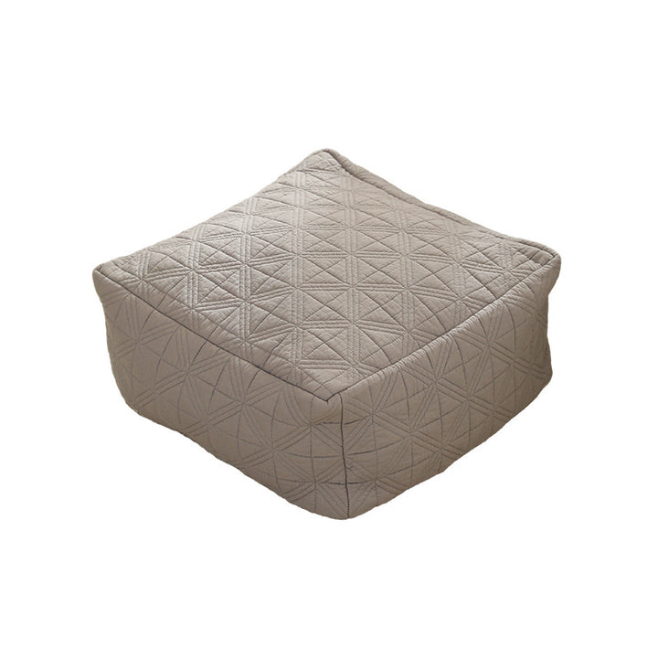 Padded footstool pouf with quilted cover fabric and shape-stable core