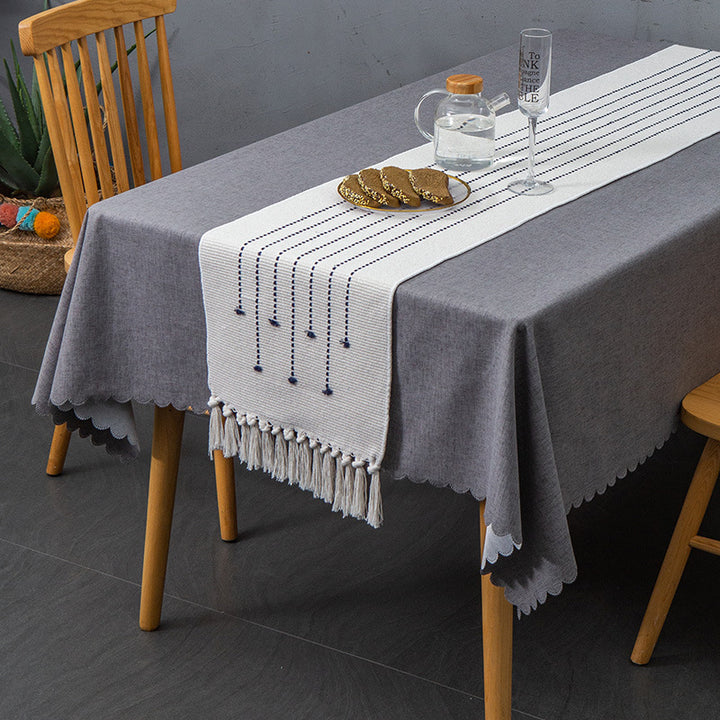 Decorative table runner in Scandinavian-minimalist design with macrame fringes Kalsten