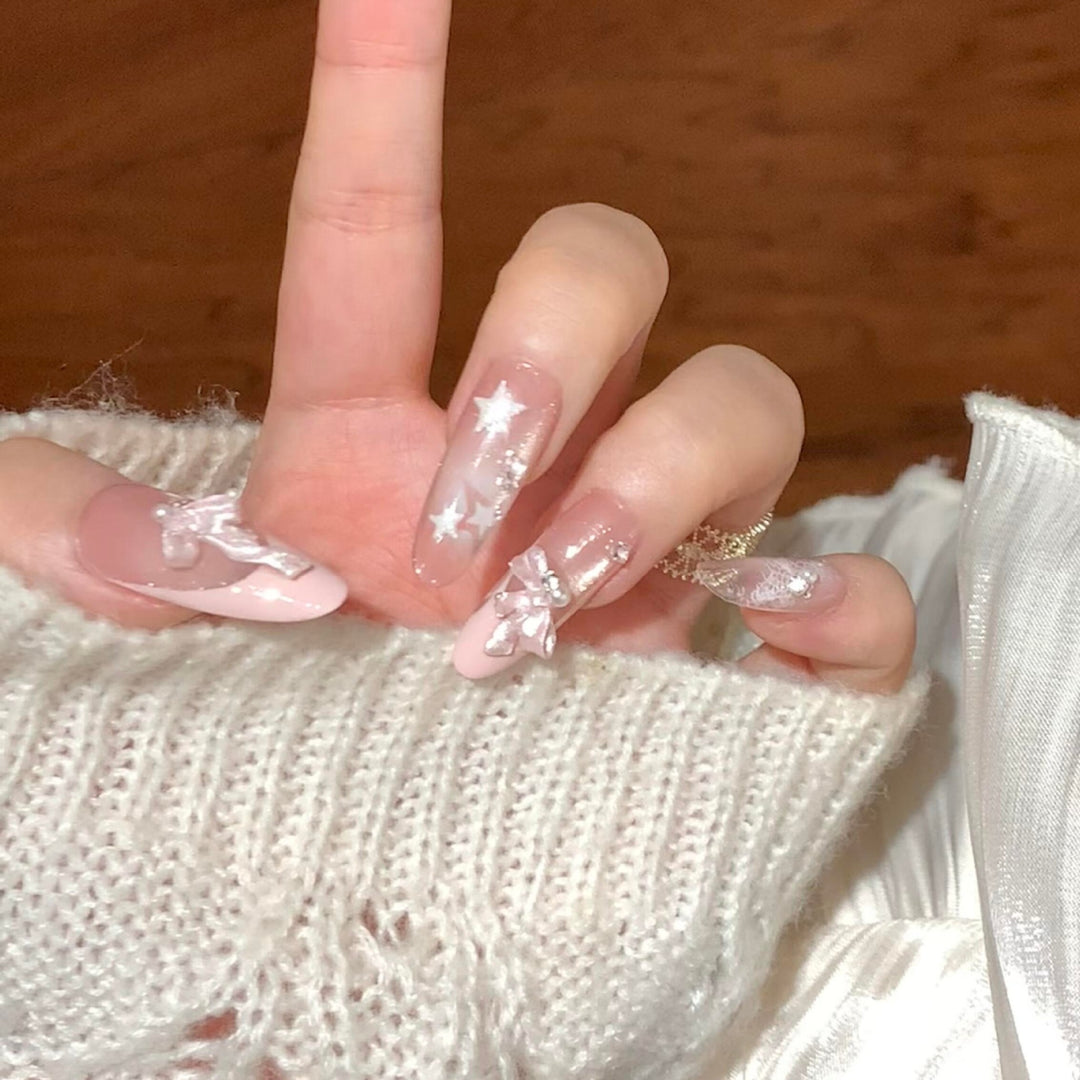 Artificial nail tips with glamorous glitter and bow details Kalsten