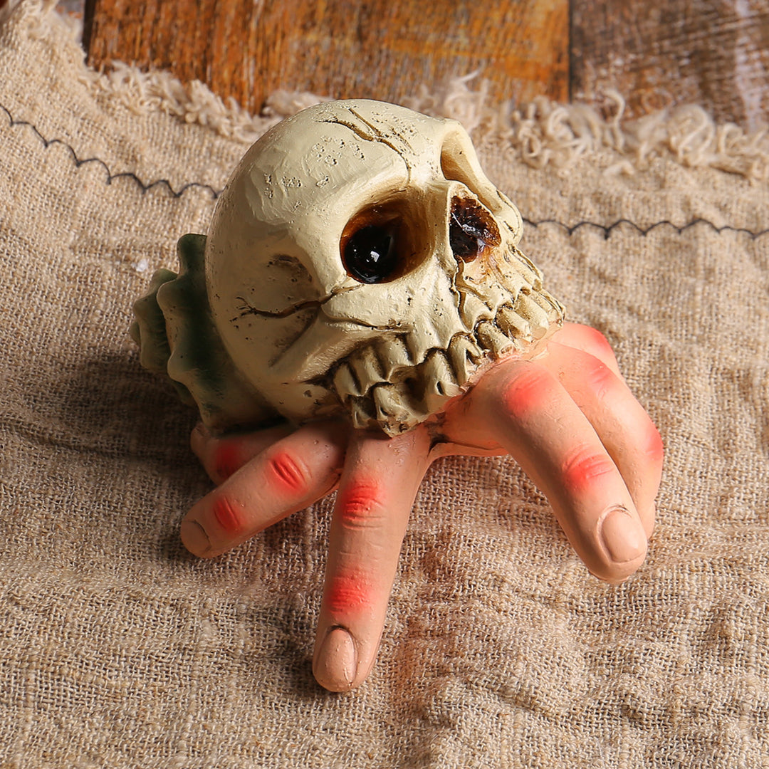Detailed Halloween decoration sculpture skull with grasping hand
