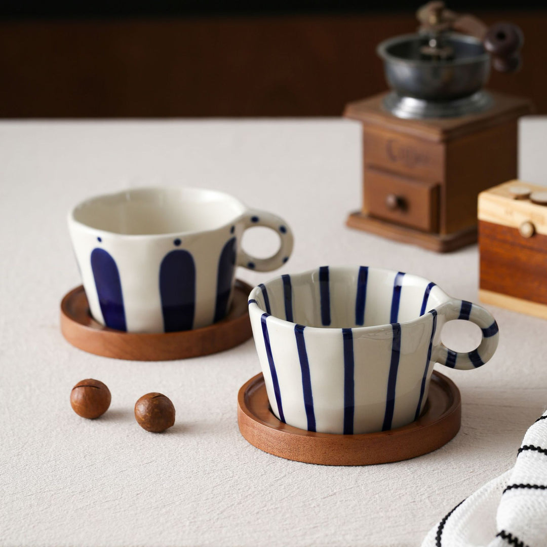 Ceramic espresso cup with round wooden coaster and handcrafted stripe pattern