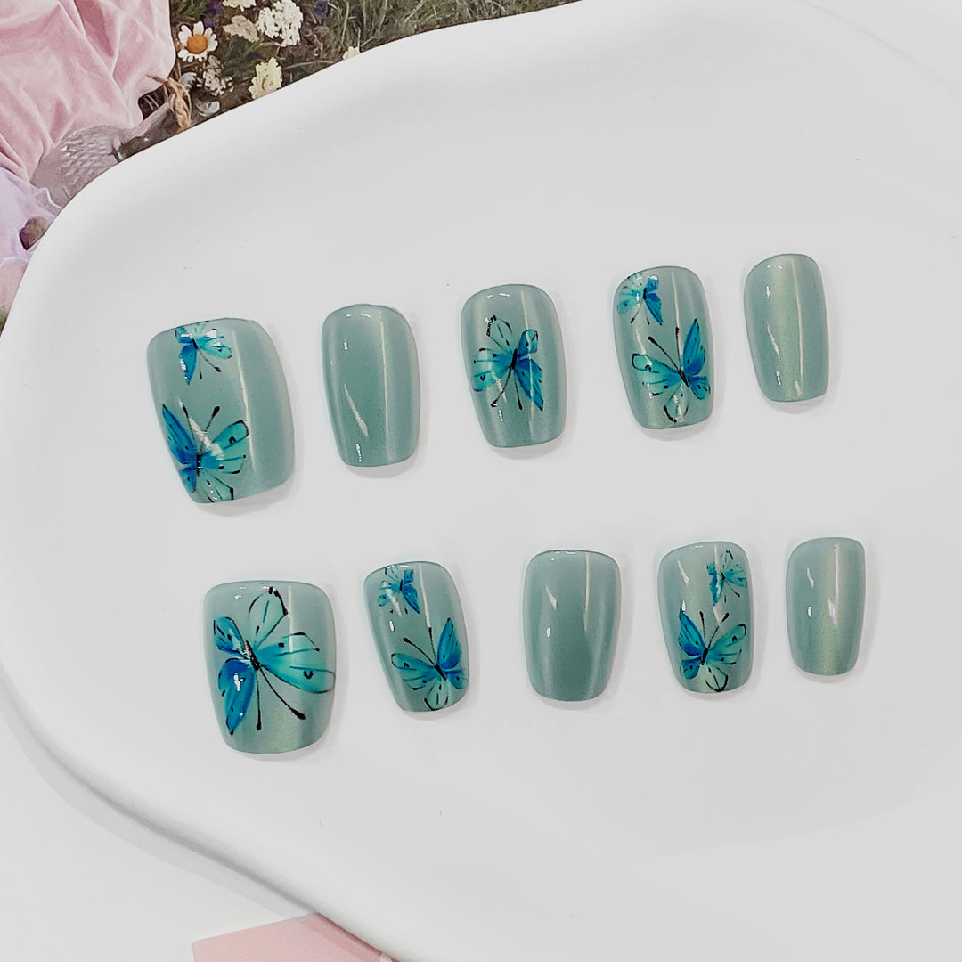 Artistic acrylic nails with butterfly motif Kalsten